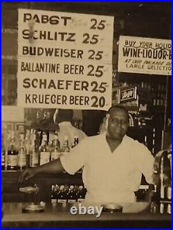 African American Liquor store owner Beer signs price on wallLouisiana