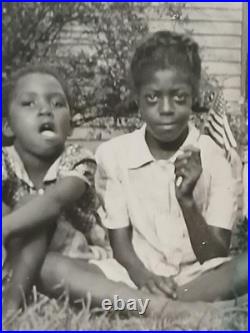 African American SchoolCOLORED STUDENTS SITTING ON GRASS HOLDING AMERICA FLAG