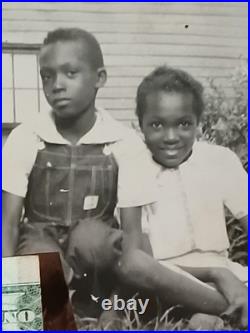 African American SchoolCOLORED STUDENTS SITTING ON GRASS HOLDING AMERICA FLAG