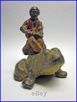 Antique solid Cast Iron Black Americana Man Riding Frog Doorstop -Extremely Rare