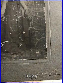 Beautiful Colored female Standing famously beside her chair holding a Bible