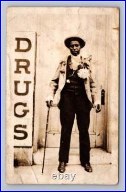 Black Man w Giant Drugs Sign RPPC Interesting Americana Photo Baldwinsville NY